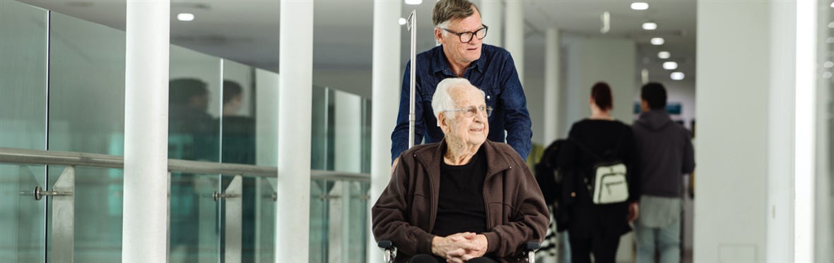 Patient in a wheelchair and his carer at Austin Hospital